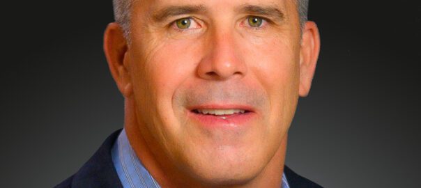 Professional headshot of smiling businessman