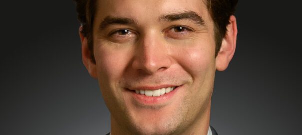 Brown-haired man in white shirt and suit