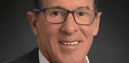 Smiling professional man in suit and glasses